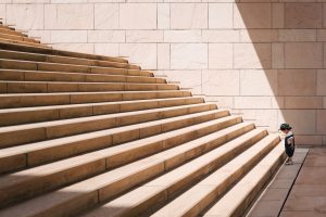 toddler's standing in front of beige concrete stair